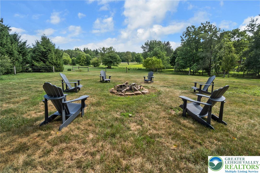 1553 Surrey Road Bethlehem, PA 18015 - Photo 85 of 92 An inviting fire pit area surrounded by Adirondack chairs offers a tranquil outdoor gathering space.
