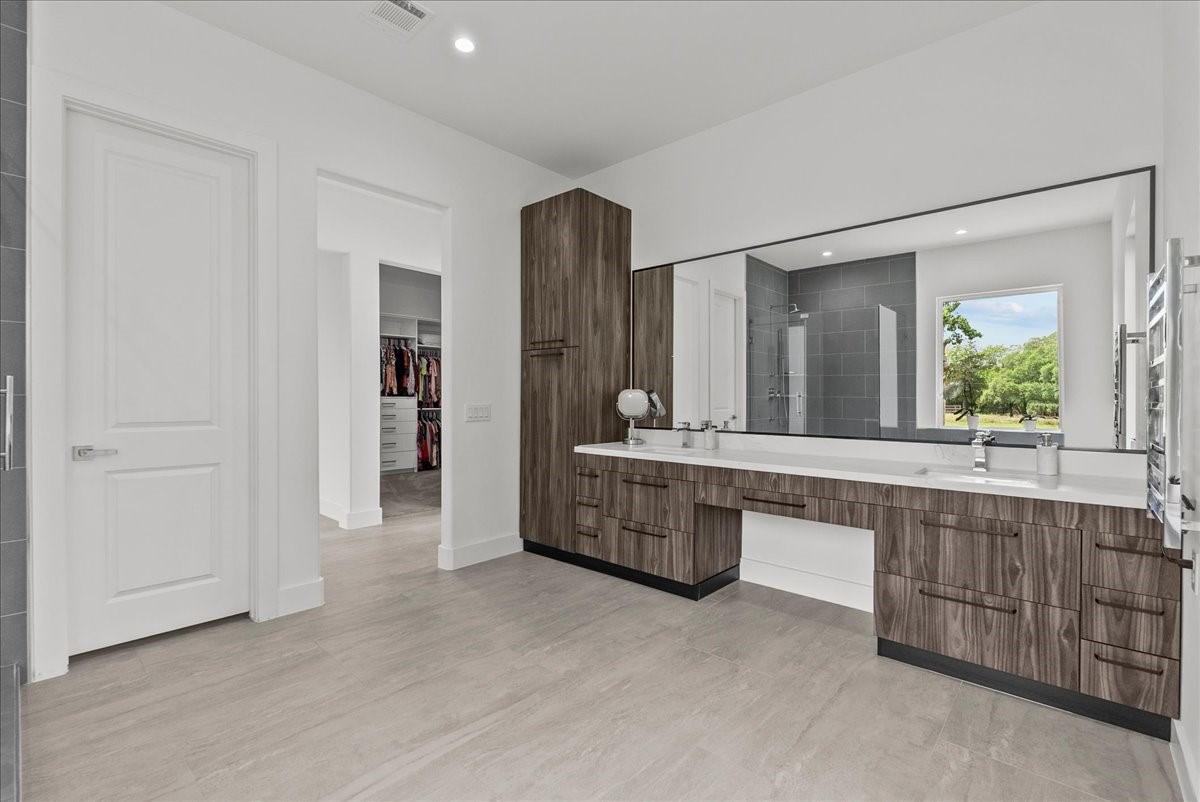 7627 Scott Avenue Manvel, TX 77578 - Photo 25 of 50 The 15 x 12 primary ensuite is a true spa-inspired sanctuary, with black teak finish cabinets and soft close drawers.