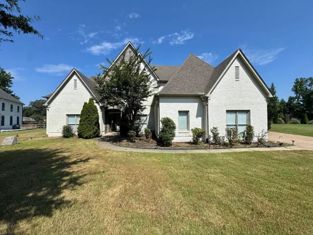 a view of a house with a yard and garage