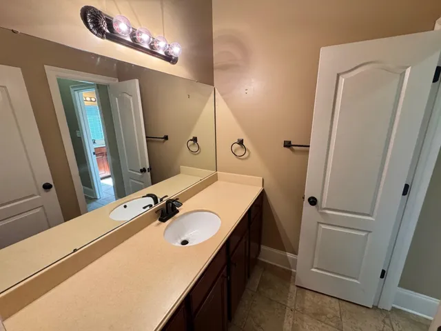 a bathroom with a sink a mirror and vanity