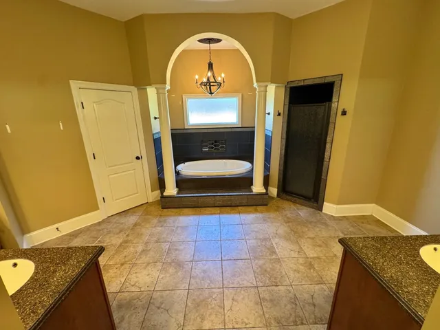 a room with a cabinets and chandelier