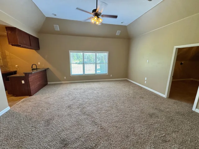 a view of a house with a backyard