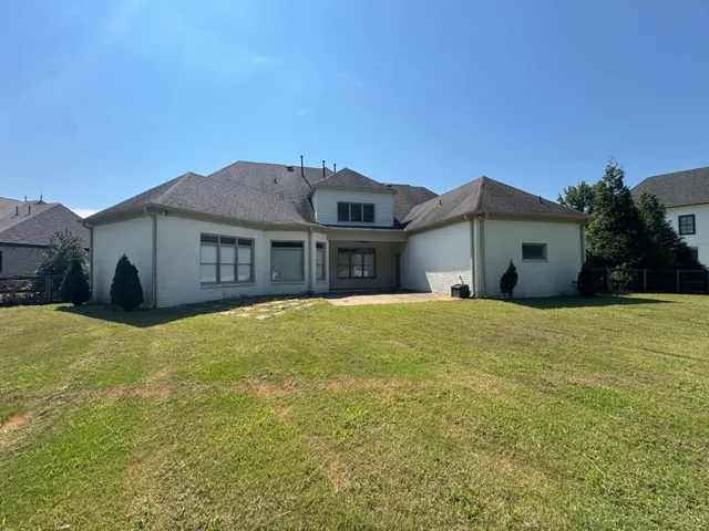 a group of people sitting in front of a house