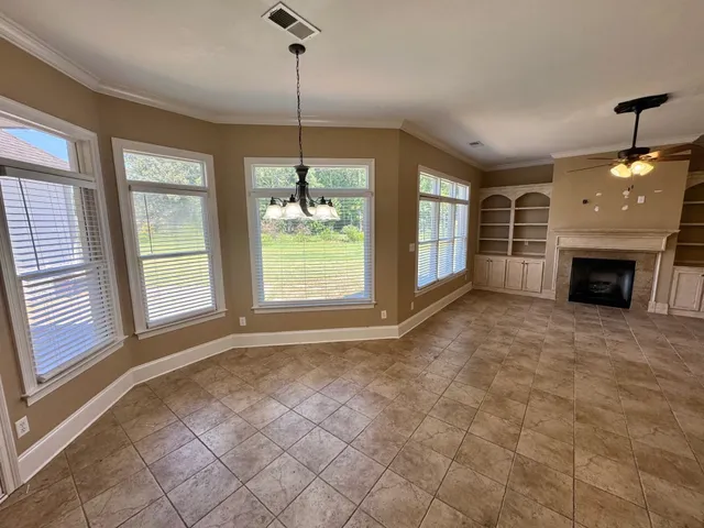 a view of livingroom with window fireplace and cabinet
