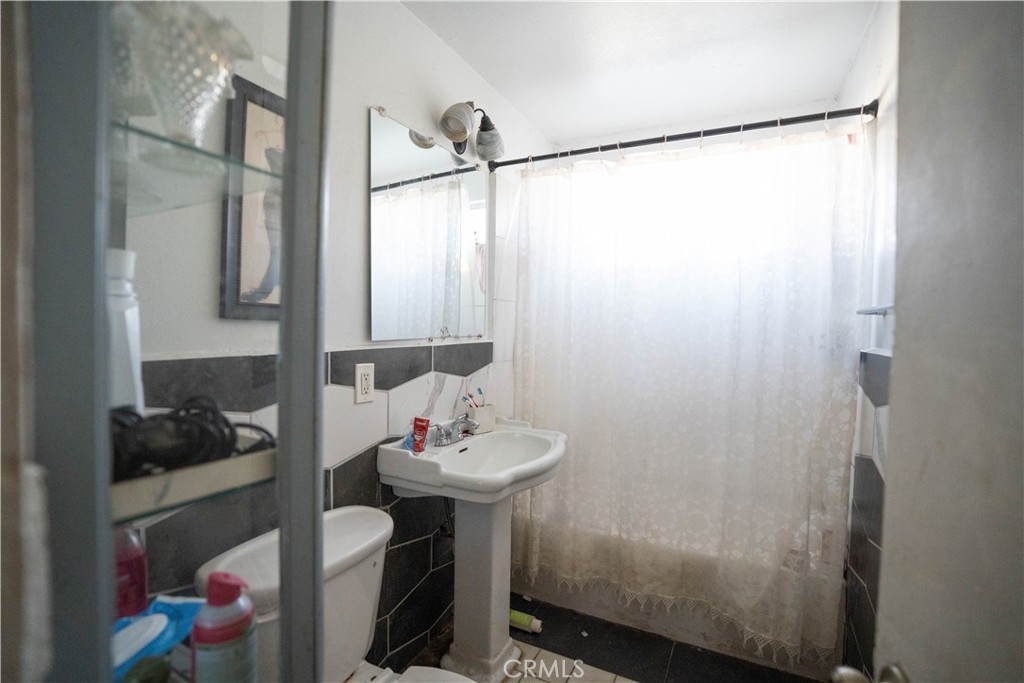 6174 Jurupa Avenue Riverside, CA 92504 - Photo 26 of 30 a bathroom with a sink and a mirror