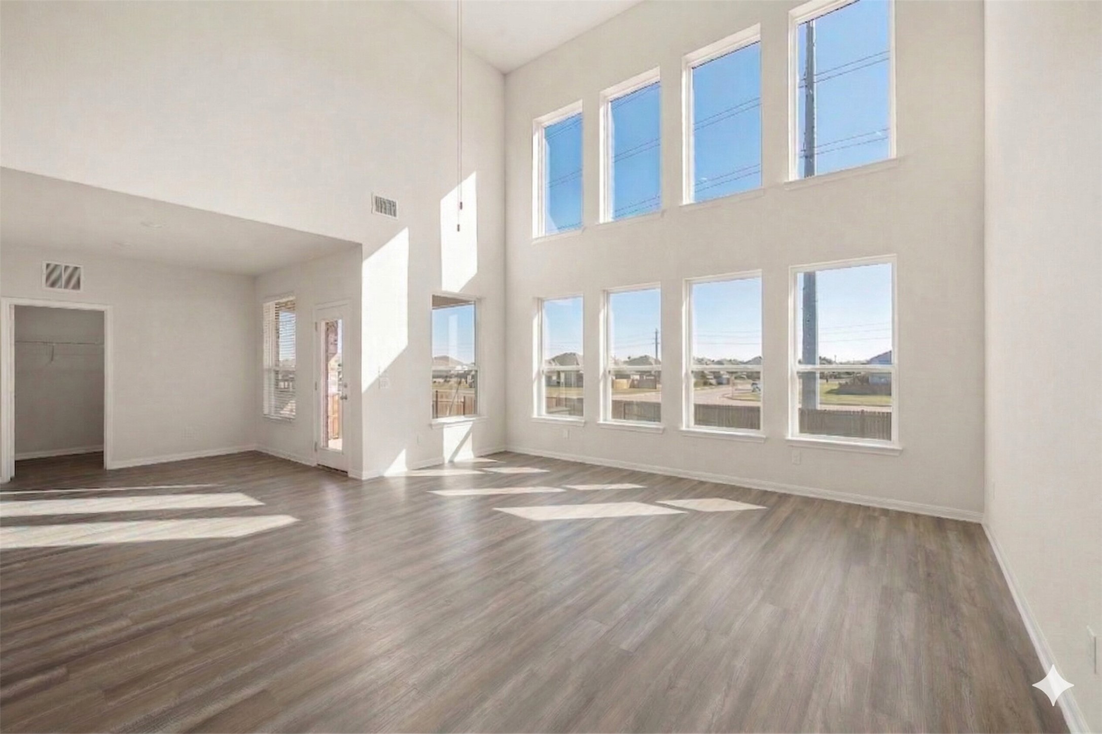604 Spindrift Lane Leander, TX 78641 - Photo 11 of 32 a view of an empty room with wooden floor and a window
