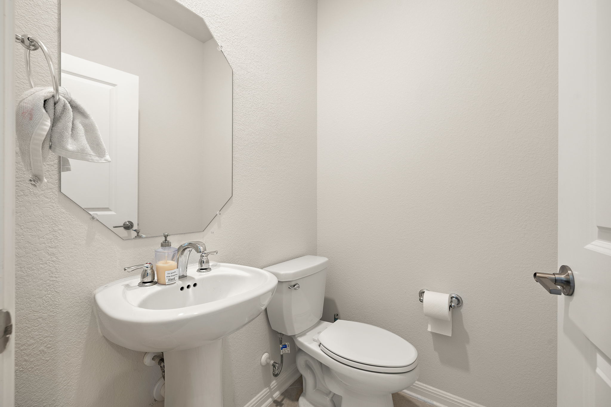 604 Spindrift Lane Leander, TX 78641 - Photo 14 of 32 a bathroom with a sink a toilet and mirror