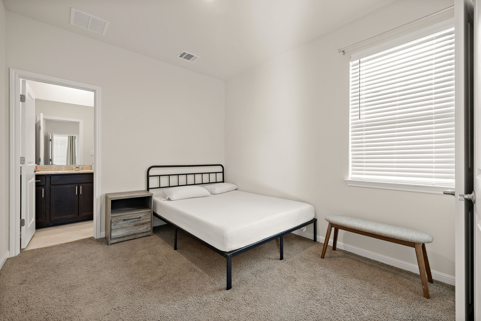 604 Spindrift Lane Leander, TX 78641 - Photo 18 of 32 a bedroom with a bed and a table