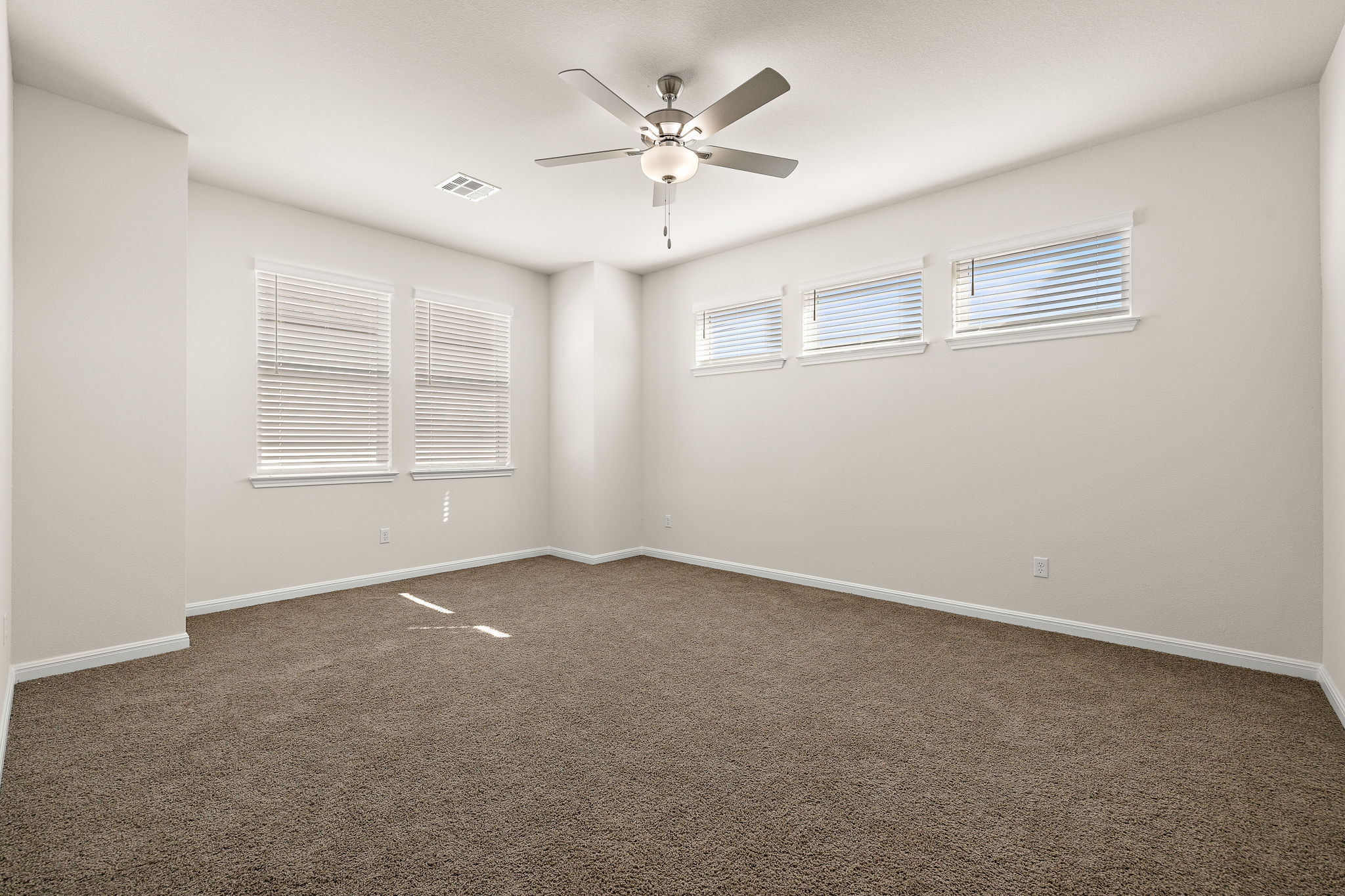 604 Spindrift Lane Leander, TX 78641 - Photo 19 of 32 an empty room with windows and ceiling fan