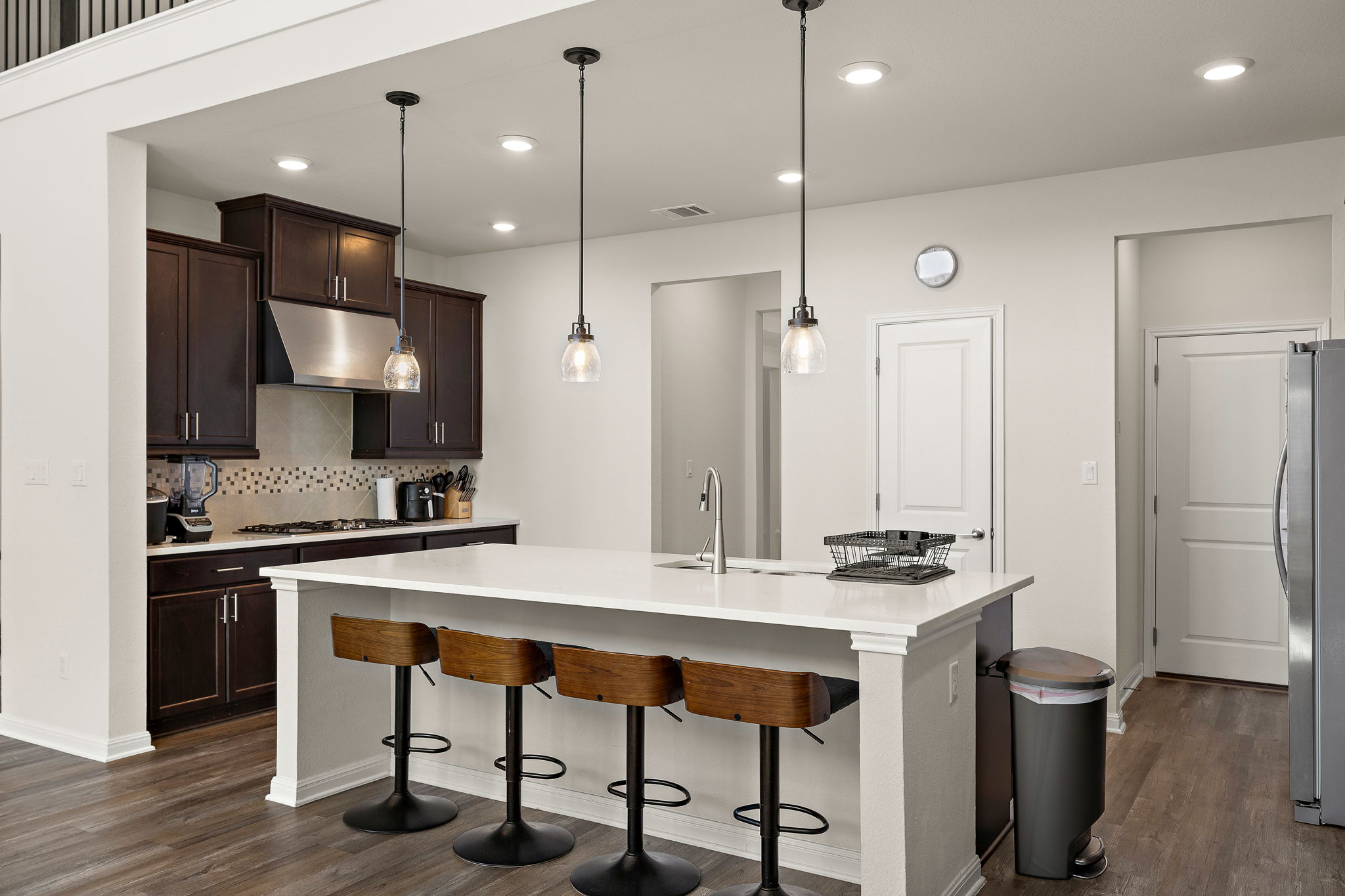 604 Spindrift Lane Leander, TX 78641 - Photo 2 of 32 a kitchen with stainless steel appliances granite countertop a stove a sink refrigerator and a microwave