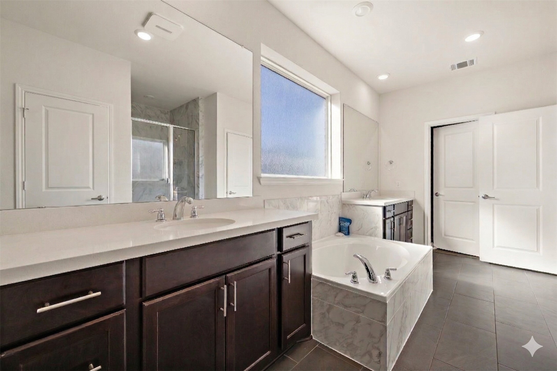 604 Spindrift Lane Leander, TX 78641 - Photo 5 of 32 a bathroom with a sink double vanity granite tub shower and mirror