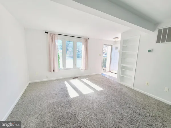 an empty room with windows and closet