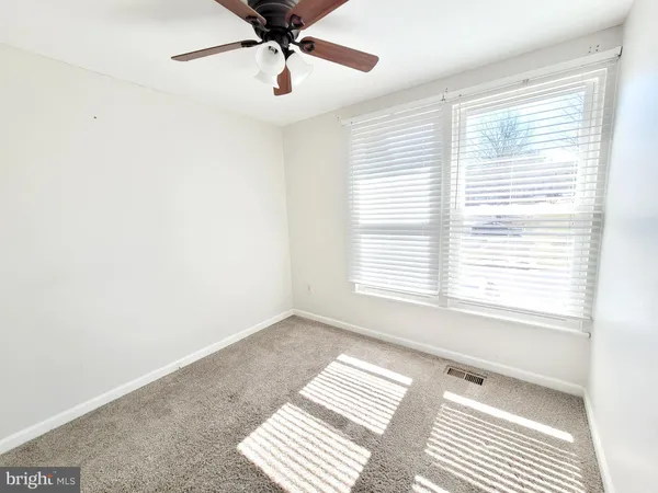 a view of a room with a window and a ceiling fan