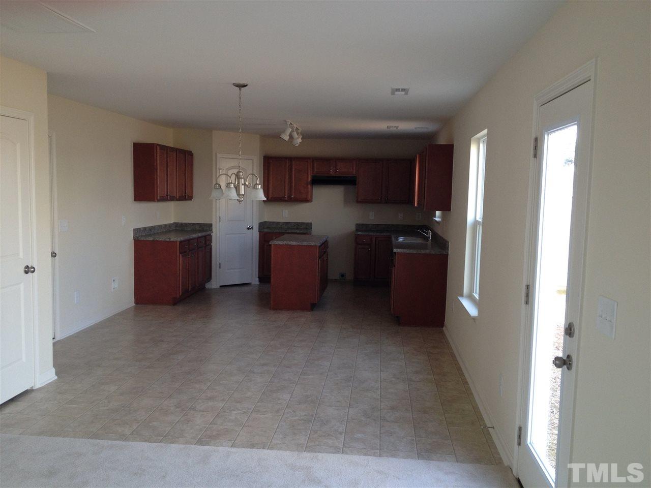 704 Pine Valley Road Creedmoor, NC 27522 - Photo 6 of 7 a kitchen with stainless steel appliances granite countertop a refrigerator and a stove top oven