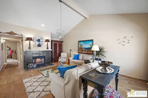 a living room with furniture a chandelier and a window