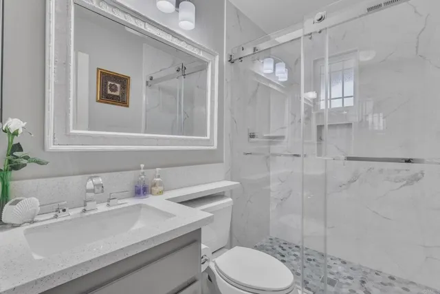 a bathroom with a sink toilet and shower