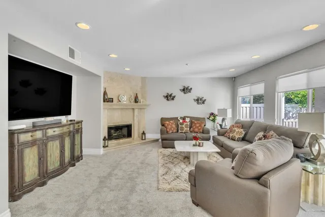a living room with furniture and a fireplace