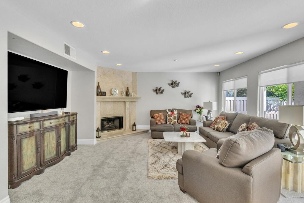 10403 Valley Waters Drive Spring Valley, CA 91978 - Photo 22 of 40 a living room with fireplace furniture and a flat screen tv
