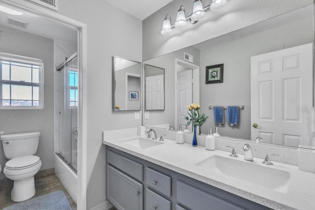 10403 Valley Waters Drive Spring Valley, CA 91978 - Photo 26 of 40 a bathroom with a toilet sink and mirror