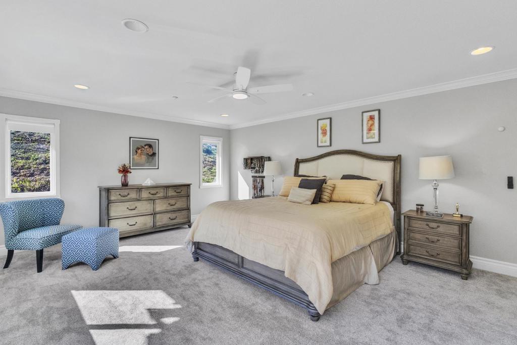 10403 Valley Waters Drive Spring Valley, CA 91978 - Photo 27 of 40 a bedroom with a large bed and a couch