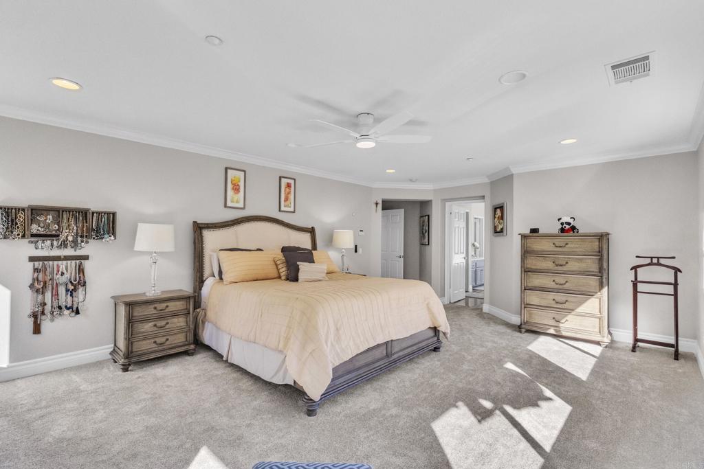 10403 Valley Waters Drive Spring Valley, CA 91978 - Photo 28 of 40 a spacious bedroom with a bed and a walk in closet