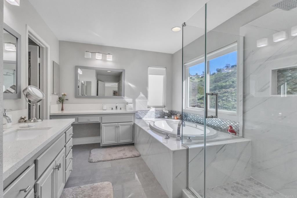 10403 Valley Waters Drive Spring Valley, CA 91978 - Photo 29 of 40 a bathroom with a double vanity sink mirror double vanity and bathtub