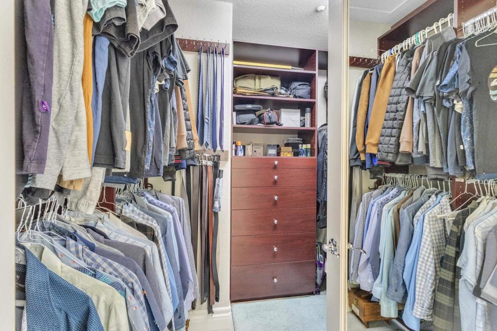 10403 Valley Waters Drive Spring Valley, CA 91978 - Photo 30 of 40 a view of walk in closet with clothes and shoes
