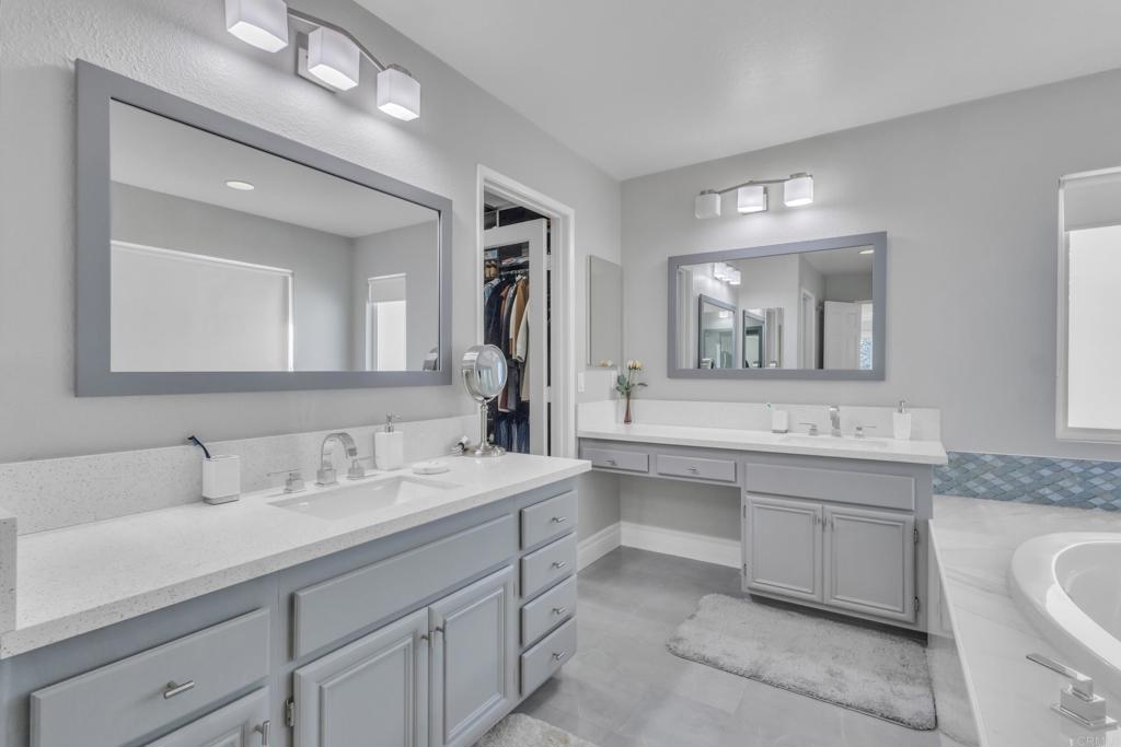 10403 Valley Waters Drive Spring Valley, CA 91978 - Photo 32 of 40 a bathroom with a sink double vanity granite and a mirror