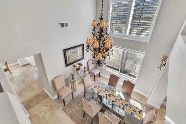 a view of a patio with a table and chairs under an umbrella