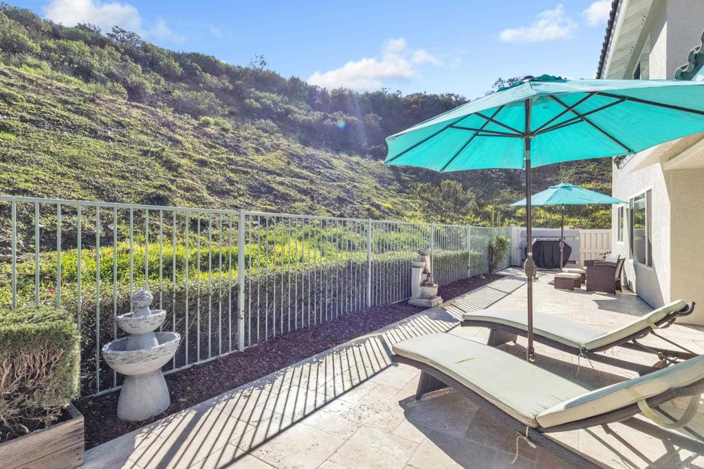 10403 Valley Waters Drive Spring Valley, CA 91978 - Photo 34 of 40 a view of a patio with a table and chairs under an umbrella