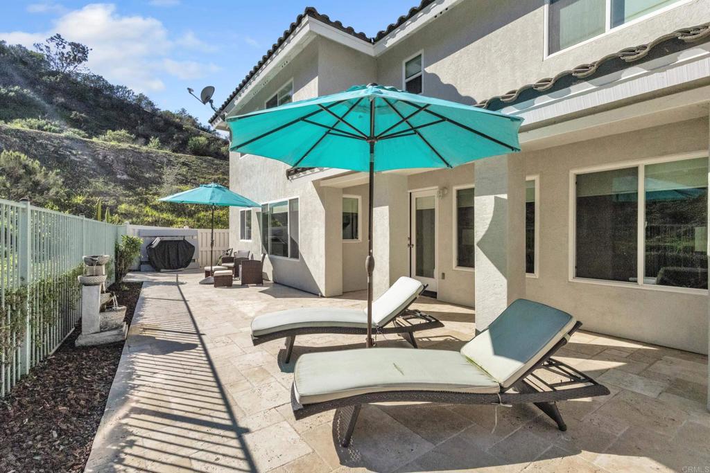 10403 Valley Waters Drive Spring Valley, CA 91978 - Photo 35 of 40 a view of a patio with a table and chairs under an umbrella