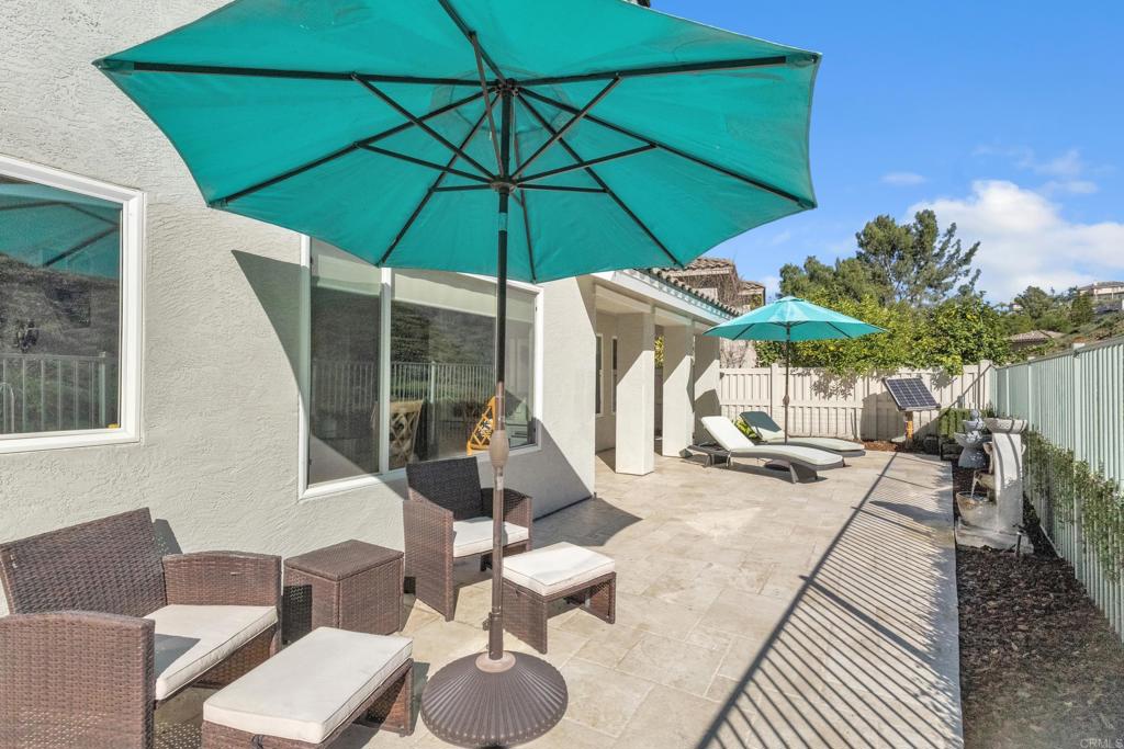 10403 Valley Waters Drive Spring Valley, CA 91978 - Photo 36 of 40 a patio with a table and chairs under an umbrella