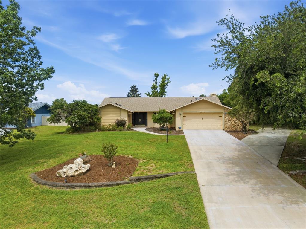5227 Suwannee Road Weeki Wachee, FL 34607 - Photo 48 of 62 a front view of a house with a yard