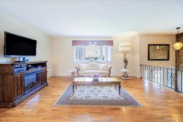 a dining room with furniture a chandelier and wooden floor