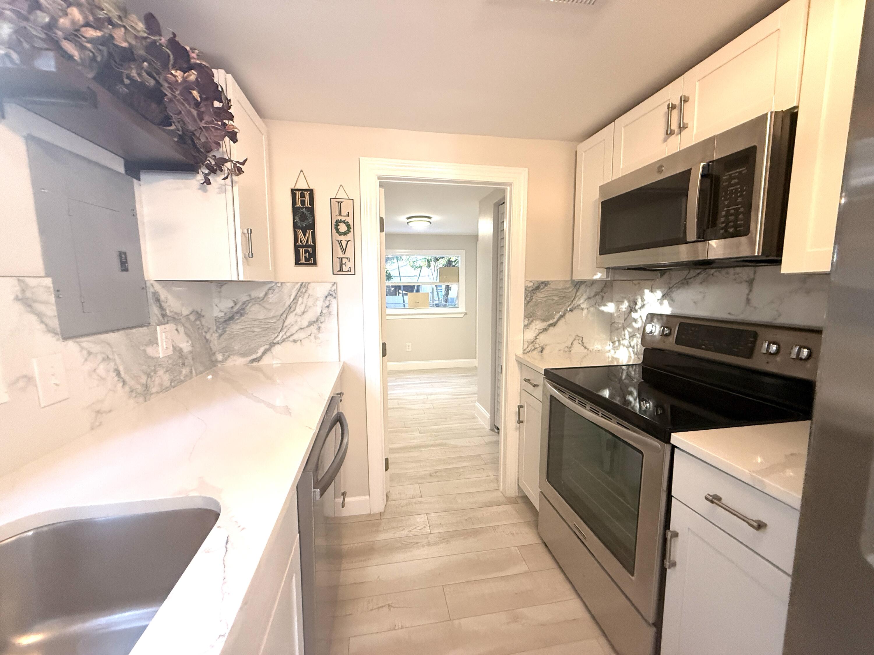 a kitchen with stainless steel appliances granite countertop a sink and a stove