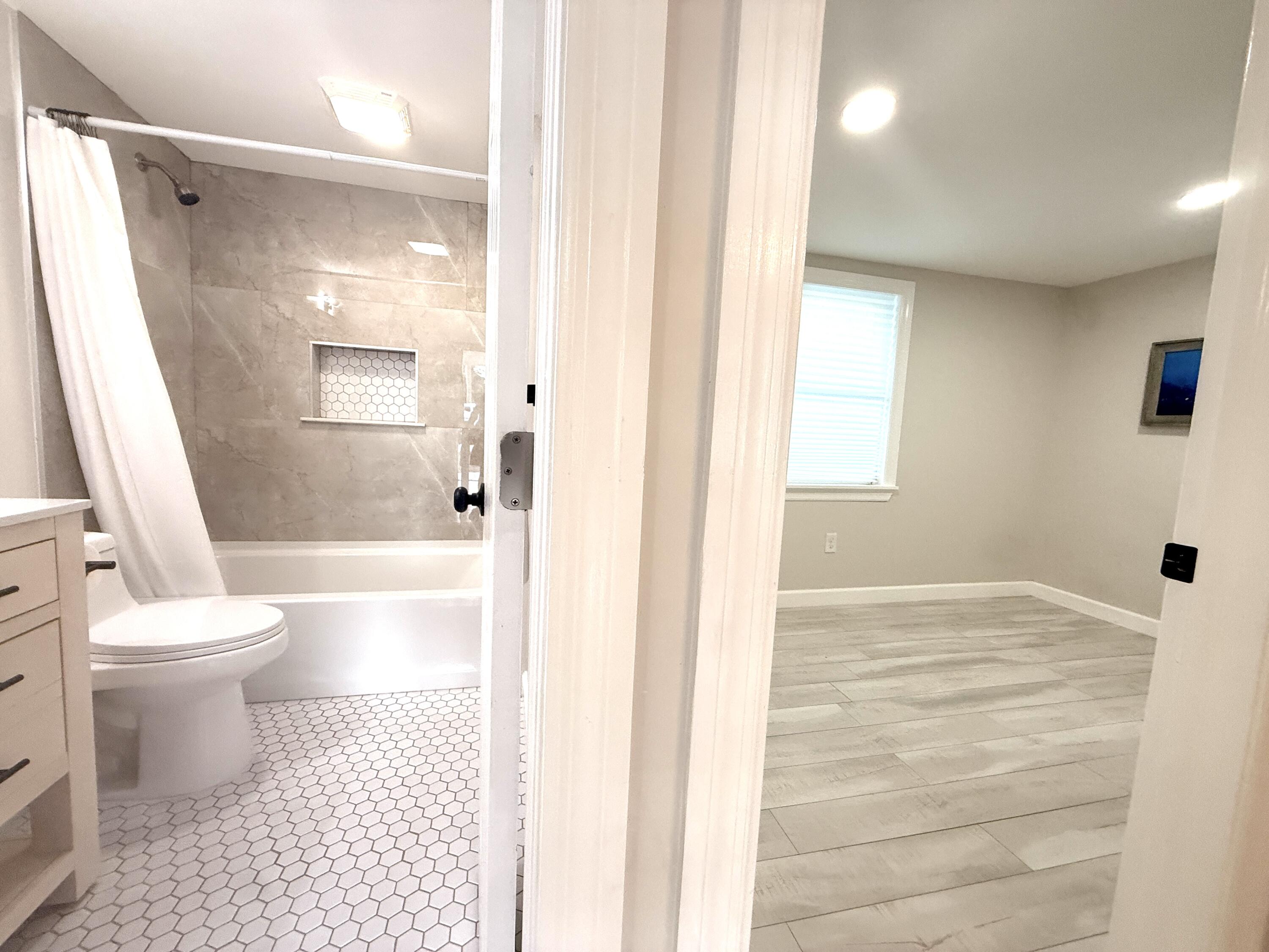 1093 Highview Road Lantana, FL 33462 - Photo 11 of 34 a bathroom with a toilet and a shower