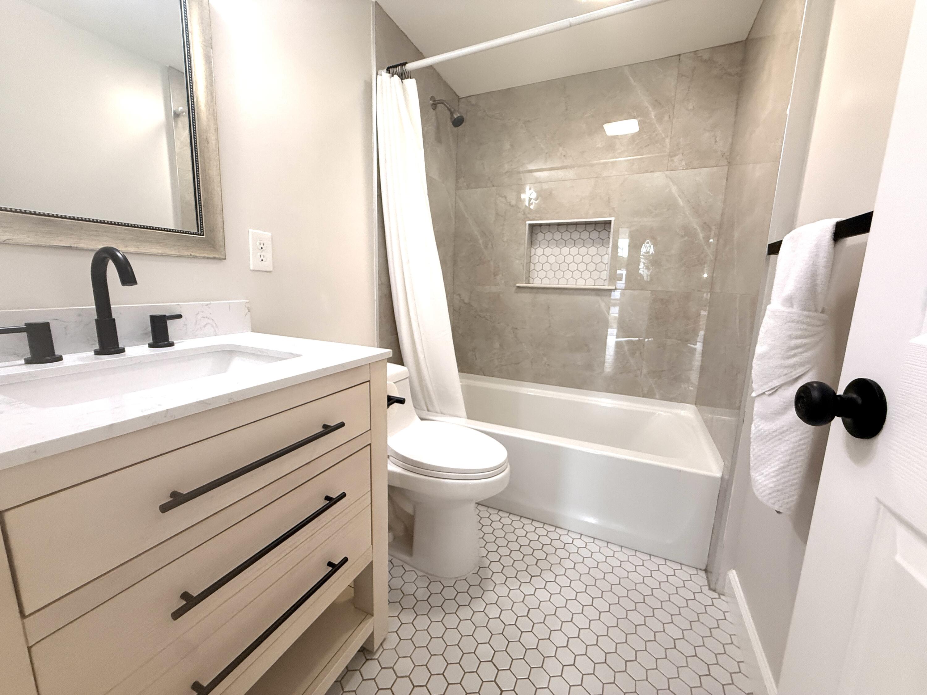 1093 Highview Road Lantana, FL 33462 - Photo 12 of 34 a bathroom with a sink a toilet and a mirror