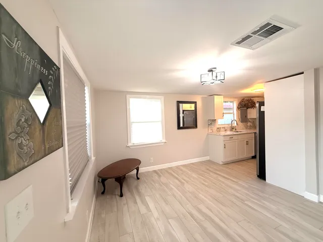 a kitchen with a refrigerator and a sink