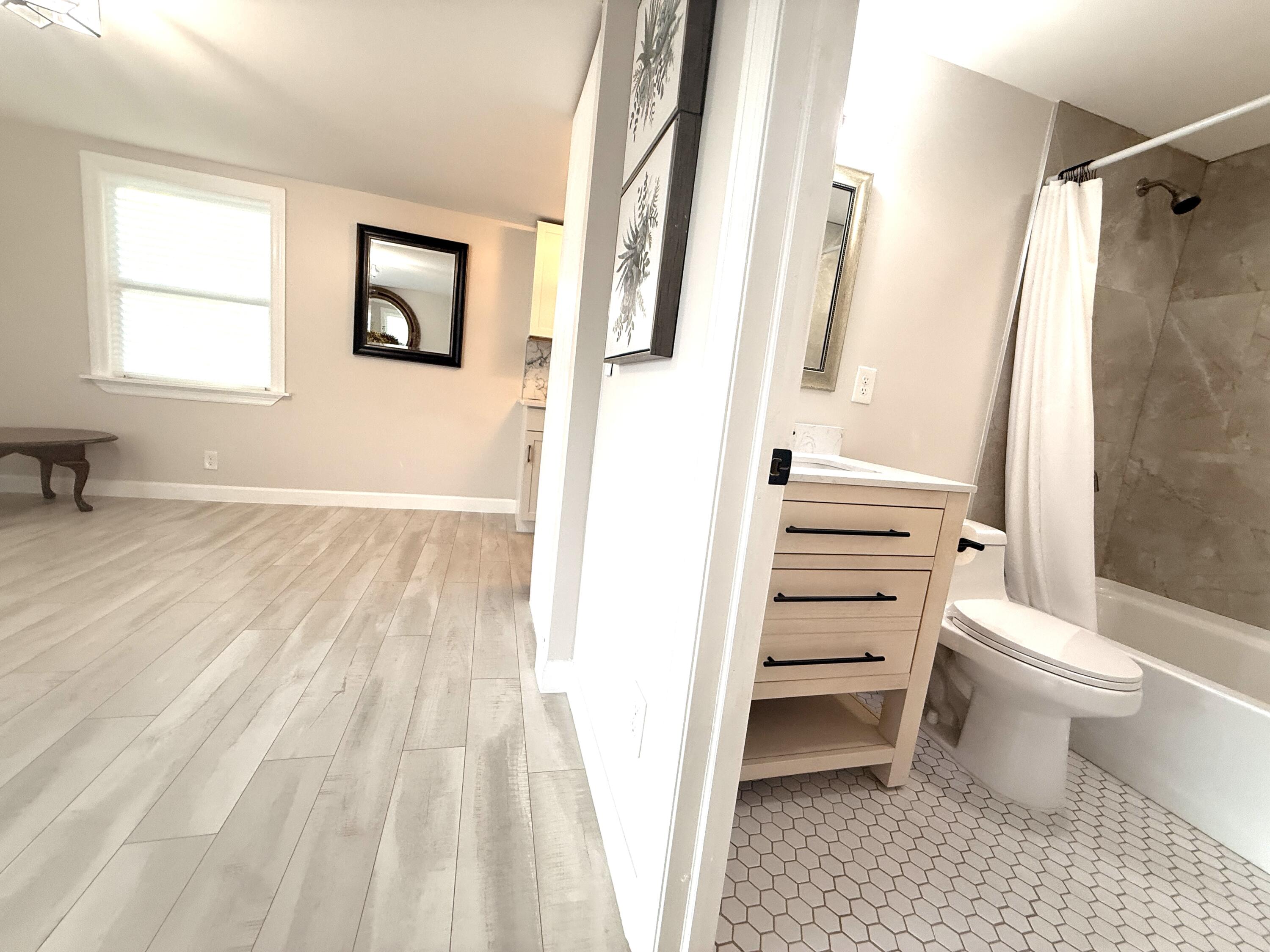 1093 Highview Road Lantana, FL 33462 - Photo 20 of 34 a bathroom with a toilet sink and a shower