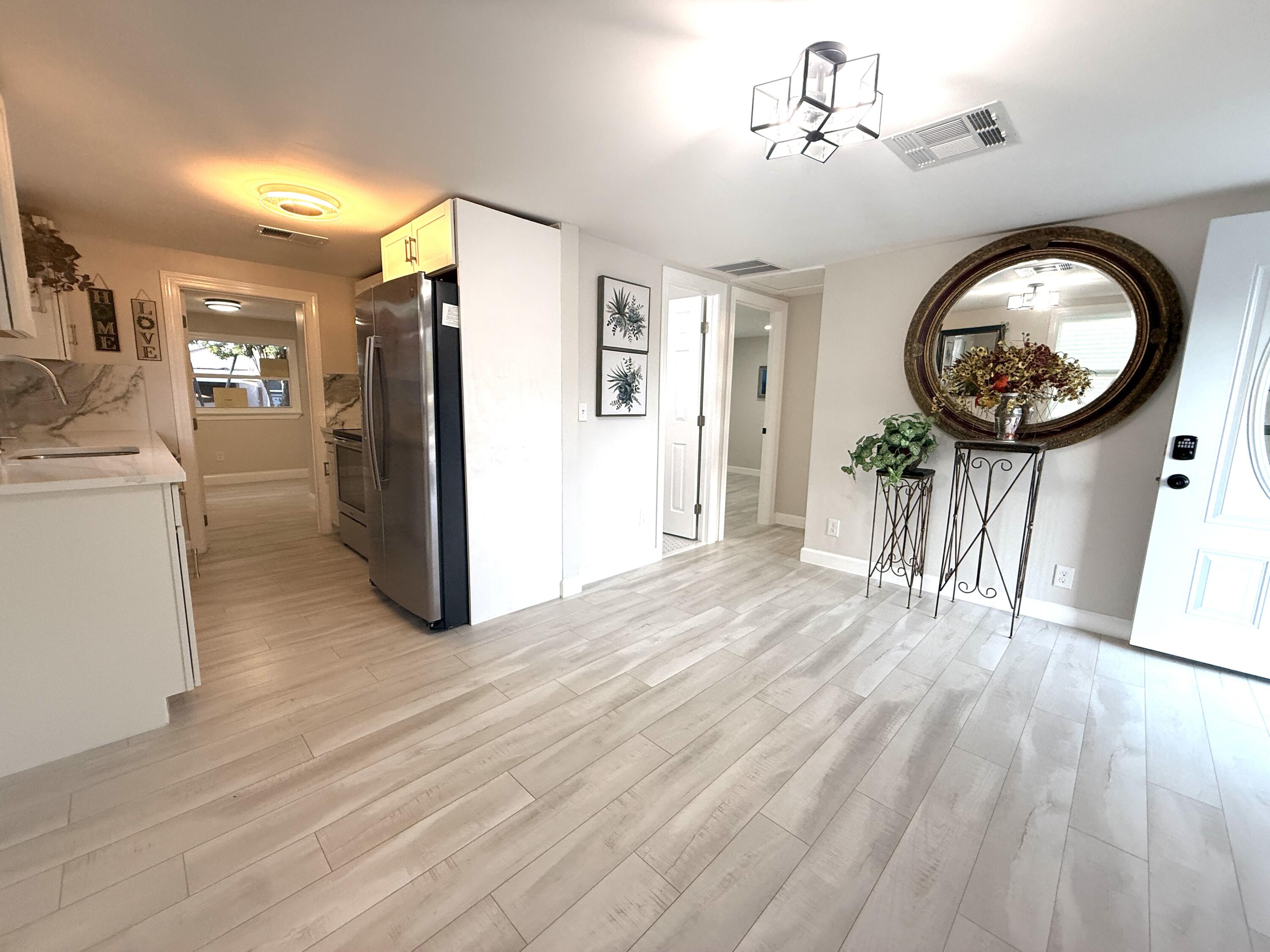 1093 Highview Road Lantana, FL 33462 - Photo 2 of 34 a view of a hallway with wooden floor