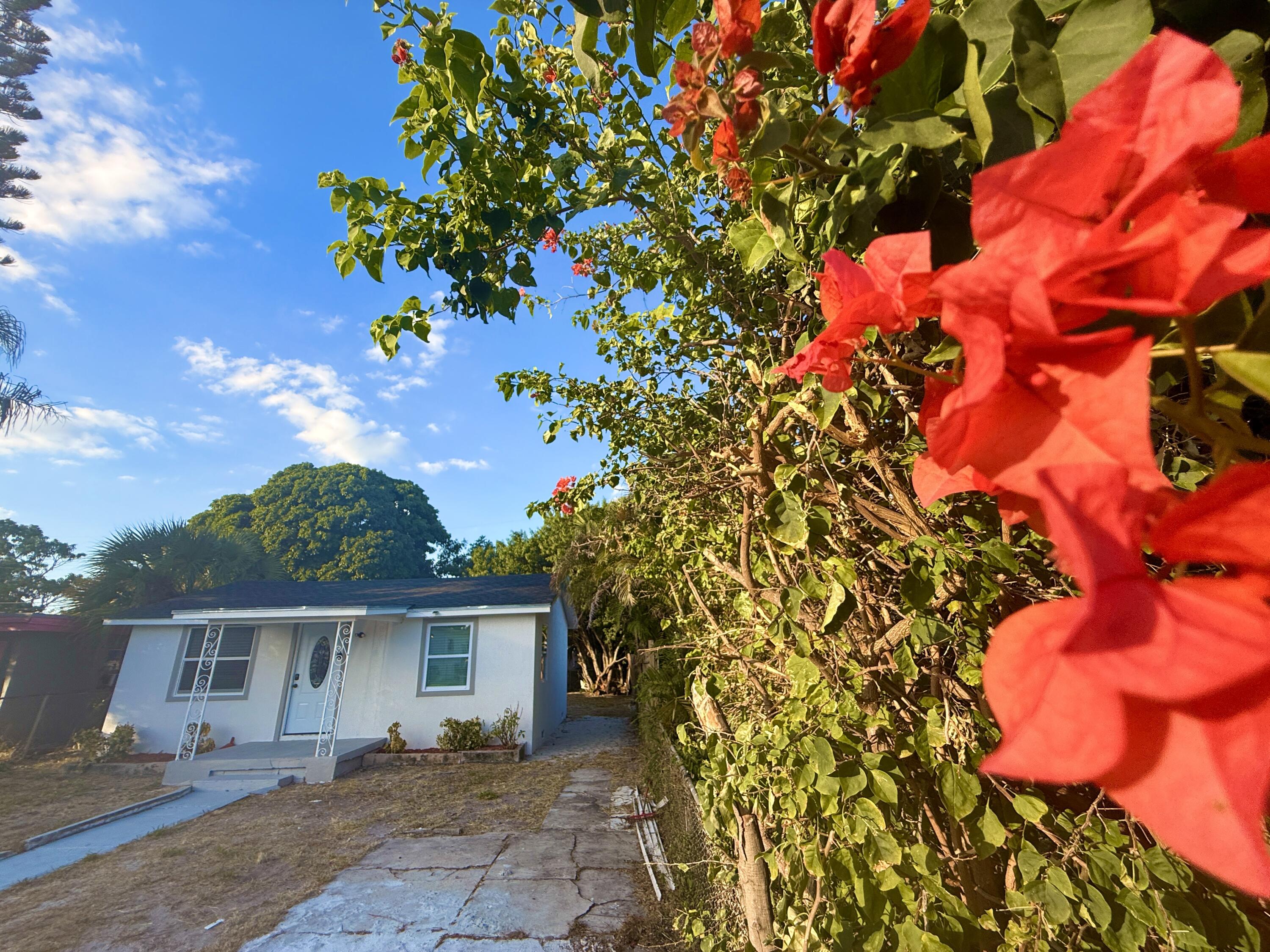 1093 Highview Road Lantana, FL 33462 - Photo 22 of 34 a front view of a house with a tree