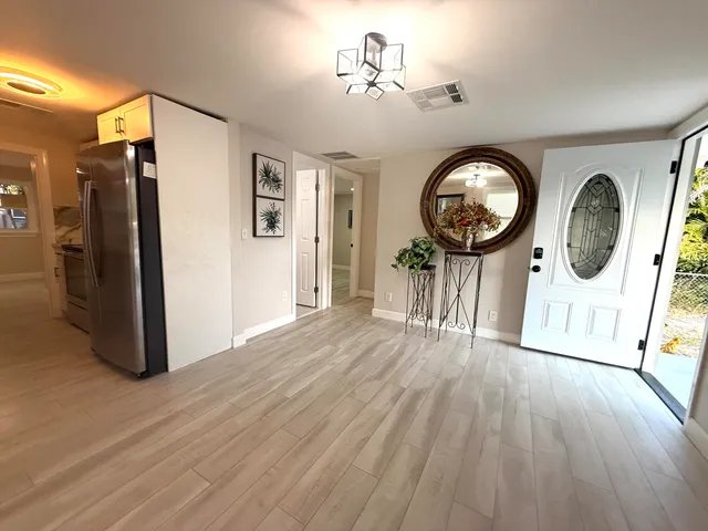 a view of a hallway with wooden floor