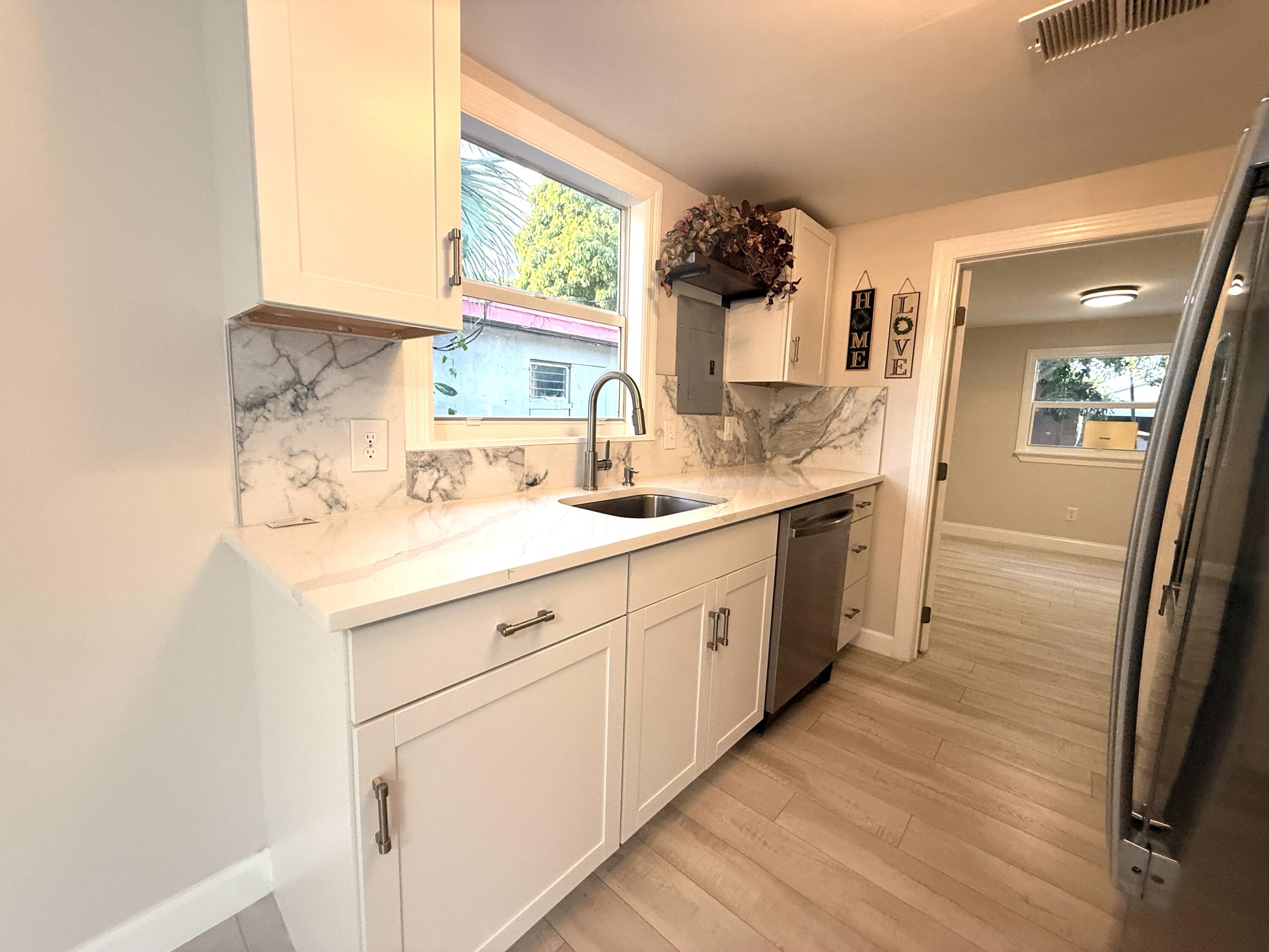 1093 Highview Road Lantana, FL 33462 - Photo 25 of 34 a spacious bathroom with a double vanity sink and a mirror