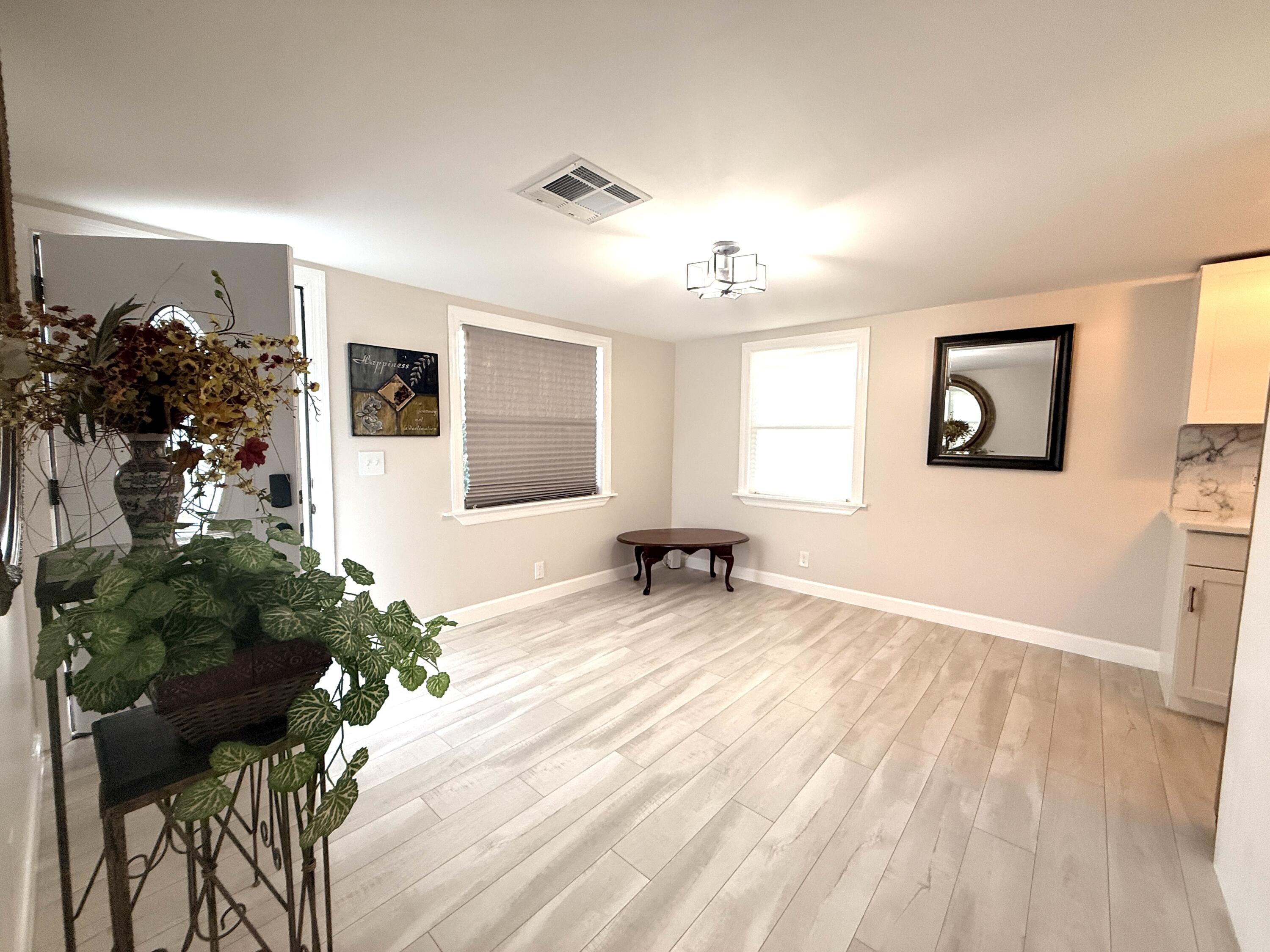 1093 Highview Road Lantana, FL 33462 - Photo 28 of 34 a view of a livingroom with furniture window and wooden floor