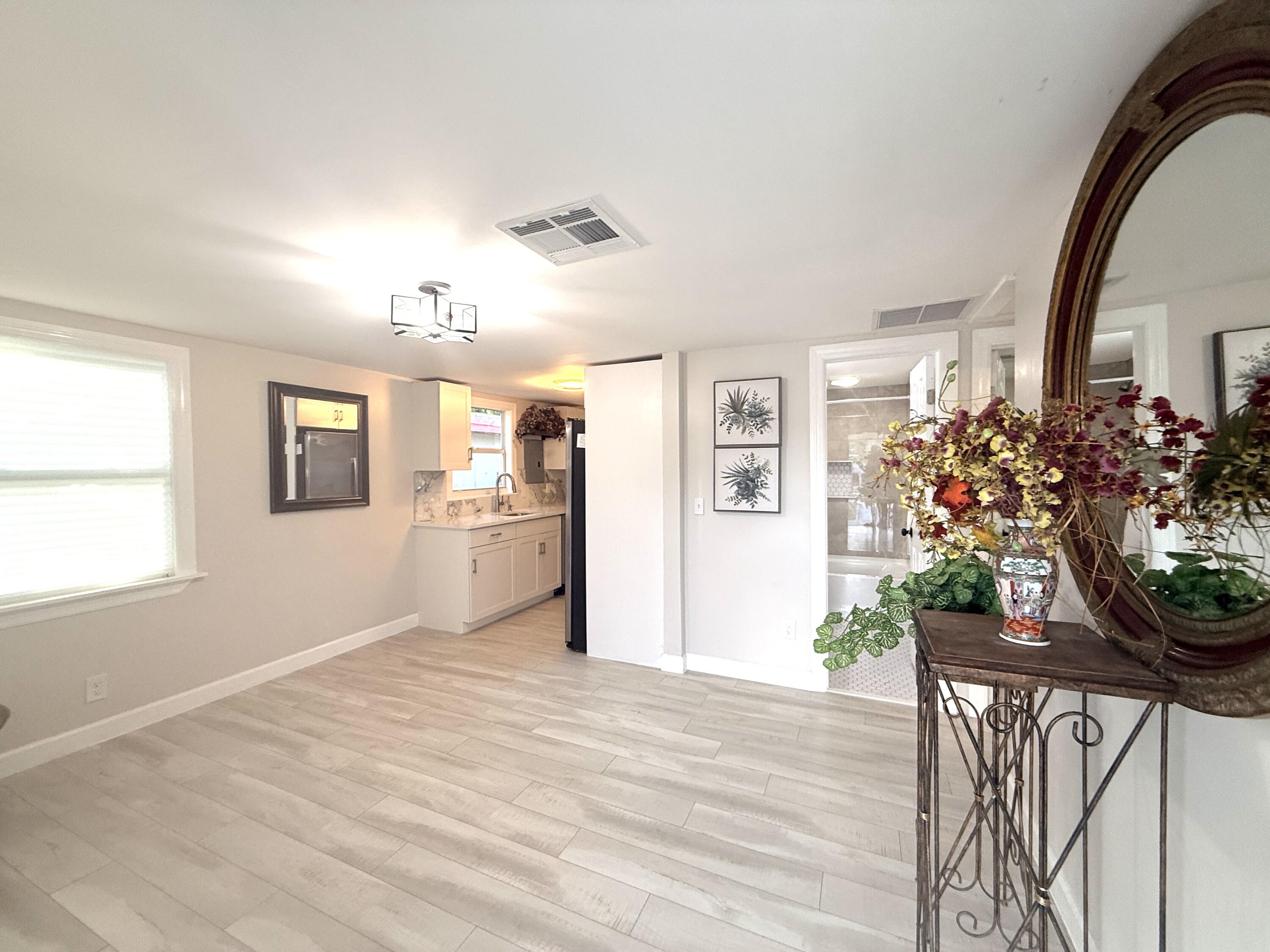 1093 Highview Road Lantana, FL 33462 - Photo 9 of 34 a view of a room with wooden floor and a window