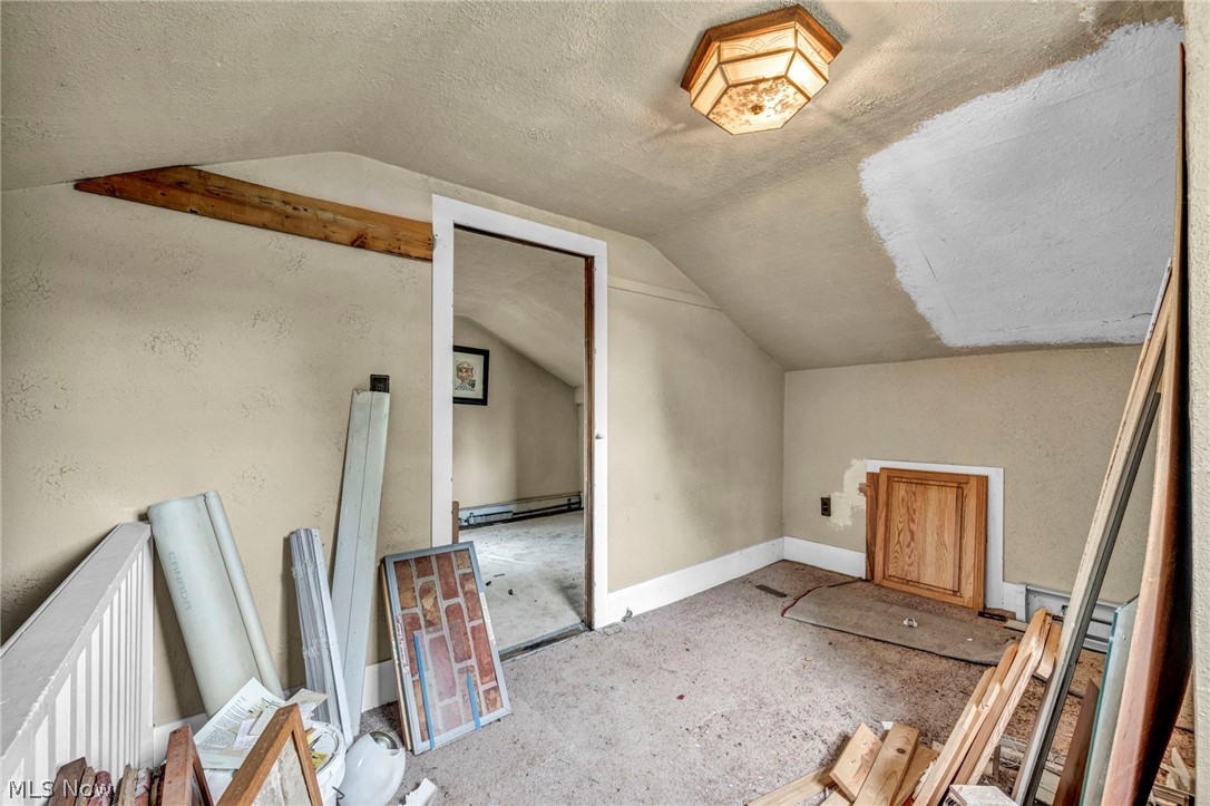 51464 North Ridge Road Vermilion, OH 44089 - Photo 28 of 37 Bonus room featuring a baseboard heating unit, a textured ceiling, and vaulted ceiling