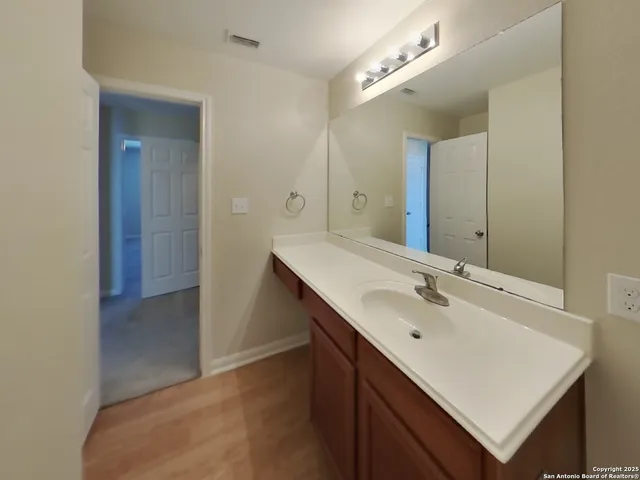 a bathroom with a sink double vanity and a mirror