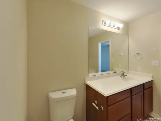 a bathroom with a sink a toilet and a mirror