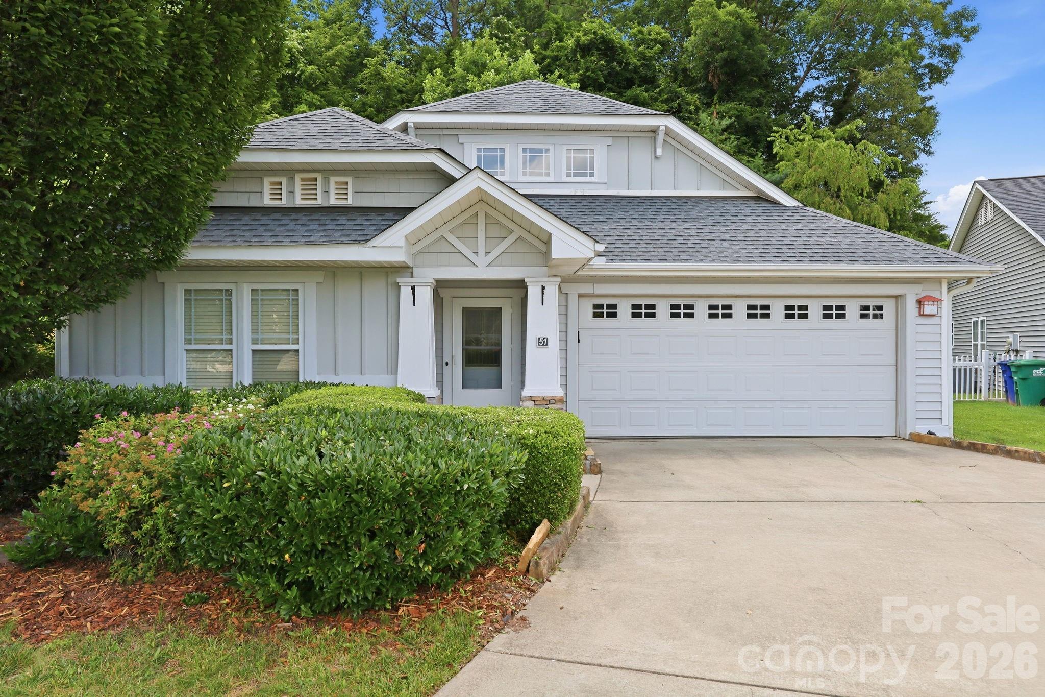 51 Sunview Circle Arden, NC 28704 - Photo 1 of 31 a front view of a house with a yard and garage
