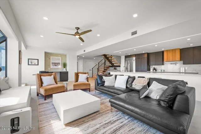 a kitchen with a refrigerator a sink and wooden cabinets